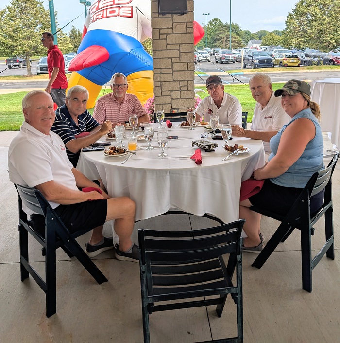 group of people enjoying the reception after 18 holes of golf